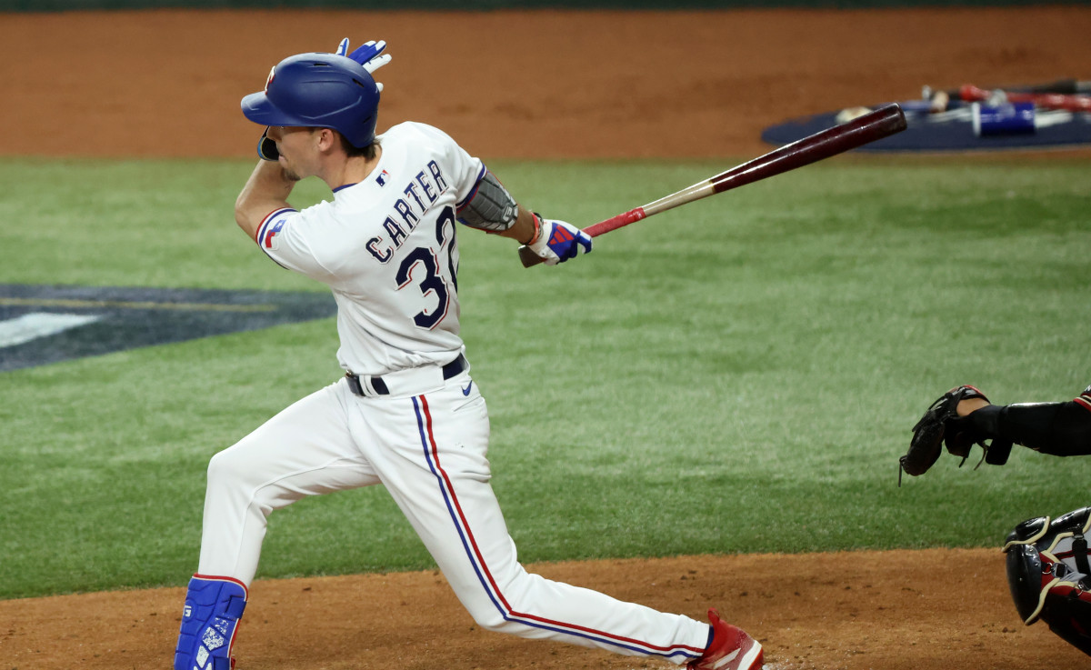 Oct 27, 2023; Arlington, TX, USA; Texas Rangers center fielder Evan Carter (32) hits a RBI double during the first inning in game one of the 2023 World Series against the Arizona Diamondbacks at Globe Life Field. Mandatory Credit: Kevin Jairaj-USA TODAY Sports